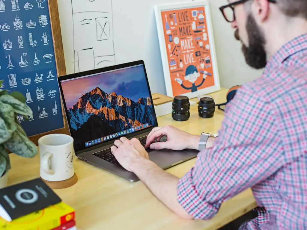 Man sitting at laptop working on blog