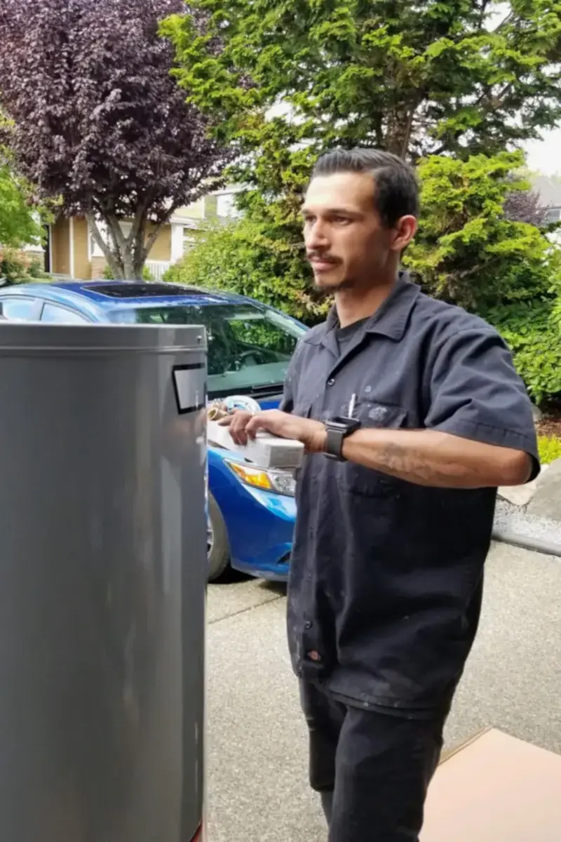 Jacob Crowell preparing water heater for installation